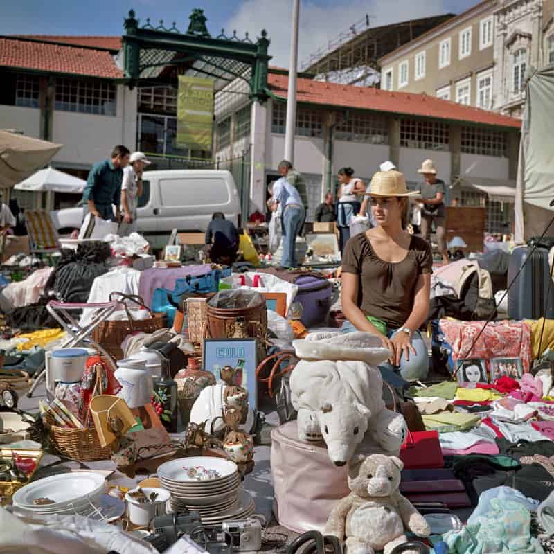 Books and vintage items spread on blankets at Feira da Ladra