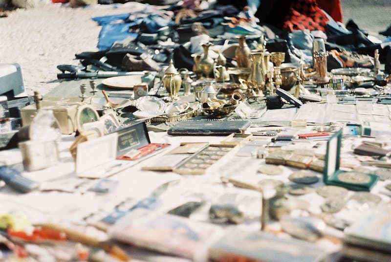 Local vendors selling second-hand goods at Feira da Ladra Lisbon