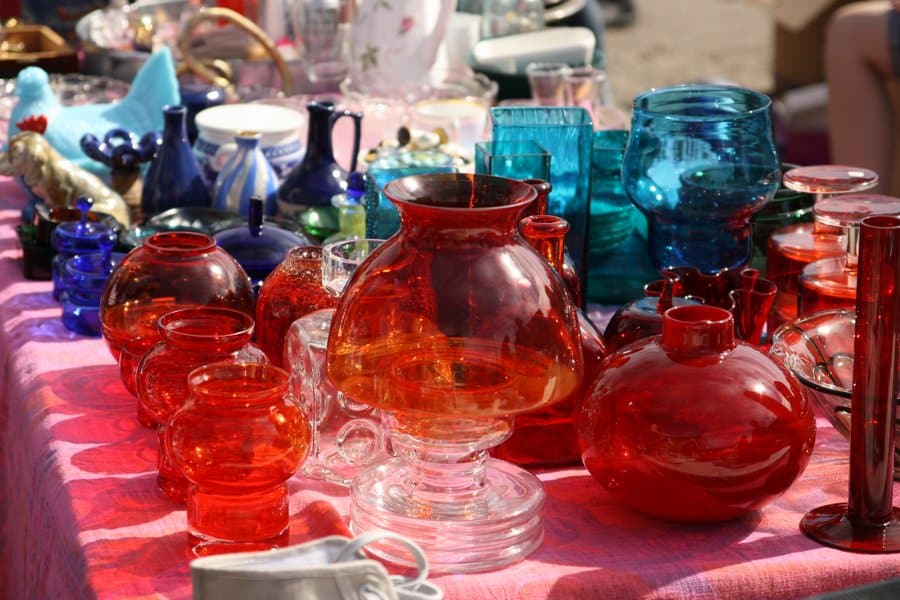 Hietalahti flea market Helsinki multicoloured vintage Finnish glassware on vendor stall