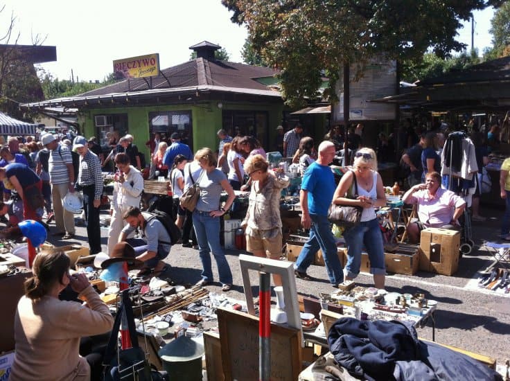 Vendors and shoppers at the Hala Targowa flea market in Krakow on a Sunday morning