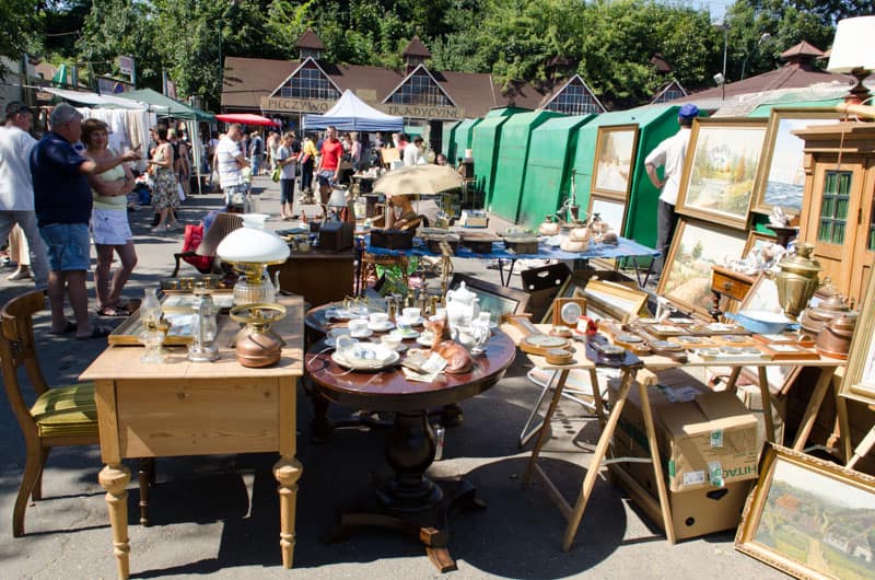 Antique items and collectibles spread across stalls at the Krakow Hala Targowa market