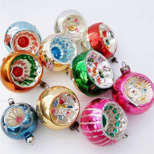 Collection of silver and gold indented reflector Christmas baubles on a tree