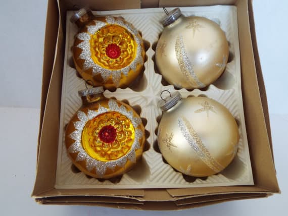 Vintage indented Christmas baubles in red and gold with reflective dimpled surface